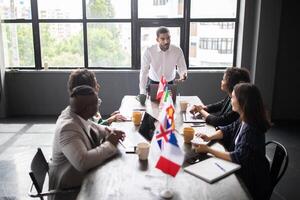 Diverse professionals engage in a collaborative meeting around a conference table, discussing strategies and ideas. photo