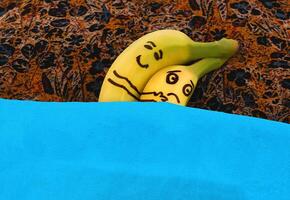 Bananas hugging each in bed. photo