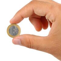 Holding one euro coin photo