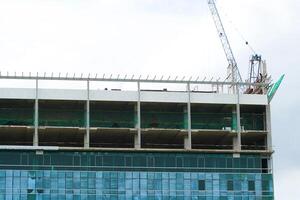 A large building under construction with a crane on top photo