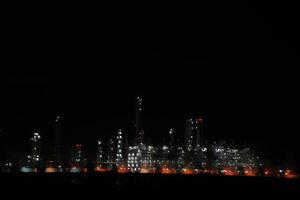 A large oil refinery at night with many lights photo