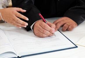 Bride and Groom Signing Marriage Certificate photo