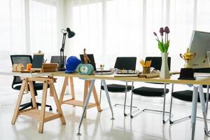 An office with a desk, chairs and a computer photo