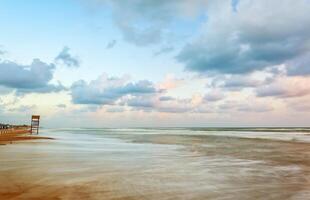 Landscape of beach with the wooden lookout tower photo