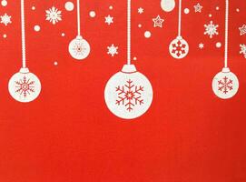 A red wall with a christmas tree and ornaments photo
