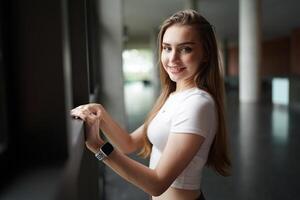 A woman is standing in front of a window photo