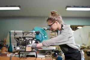A woman working on a woodworking machine photo