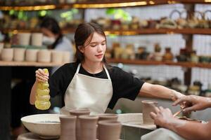 A woman is making a pottery bowl photo