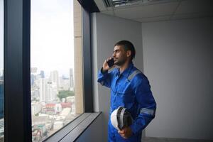 A man in a blue uniform talking on the phone photo