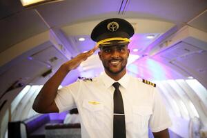A man in uniform saluting while standing in an airplane photo