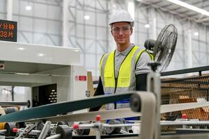 A man in a safety vest working on a machine photo