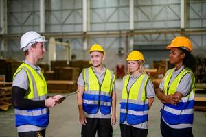 Four people in safety vests talking to each other photo