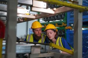 Two people working in a factory with machinery photo