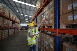 Two people in a warehouse looking at boxes photo