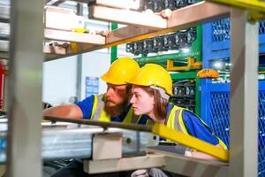 Two people working in a factory photo