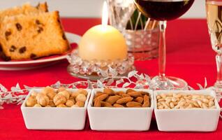Pine nuts, almonds and hazelnuts in bowls on the Christmas table photo