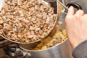 Cooking pasta with meat and mushrooms photo