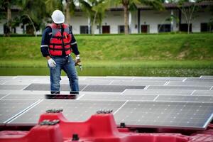 A man in a life jacket standing on top of a boat with solar panels photo