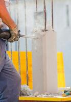 Breaking reinforced concrete with jackhammer photo