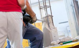 Breaking reinforced concrete with jackhammer photo