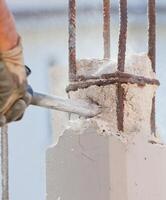 Breaking reinforced concrete with jackhammer photo