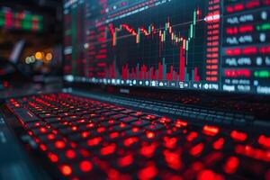 Digital Trading Platform with Real-Time Market Analysis on a Red-Lit Keyboard photo