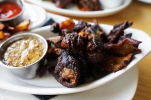 Close up deep fried chicken skin served with dipping sauce photo