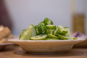 Ajad, or a side dish to eat with pork stew, is made from sliced cucumbers. photo
