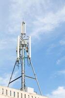 A tower with a cell phone tower on top photo