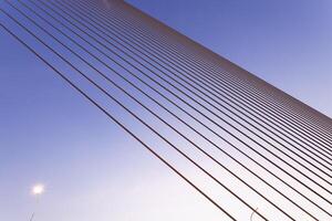 A bridge with a blue sky and a light photo