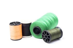 Several spools of thread and thread on a white background photo