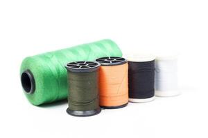 Several spools of thread and thread on a white background photo
