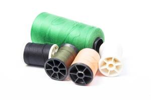 Several spools of thread and thread on a white background photo