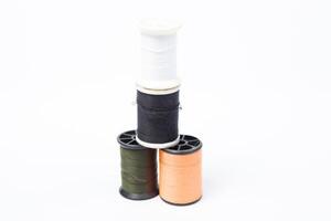 Three spools of thread on a white background photo