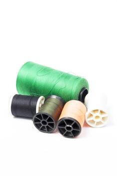 Several spools of thread and thread on a white background photo
