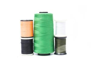Several spools of thread with different colors photo