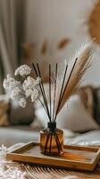 Reed diffuser in a brown glass vase on a wooden tray photo