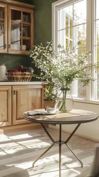A kitchen with a table and flowers in a vase photo