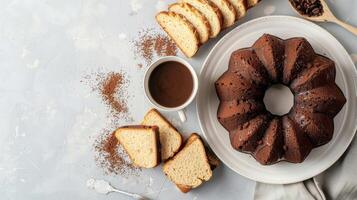 A bundt cake with chocolate icing and coffee on a plate photo