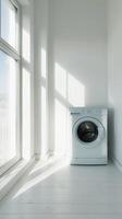 a modern white laundry room interior featuring a washing machine and dryer, with a window positioned on the left side. photo