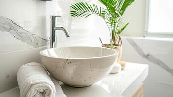 A bathroom sink with a white marble bowl photo