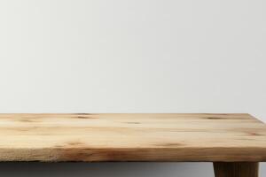 A wooden table against a plain wall background. photo