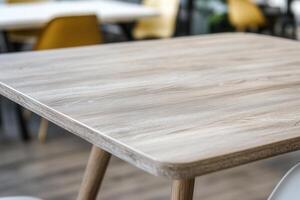 Close-up of a wooden table surface in a modern setting. photo