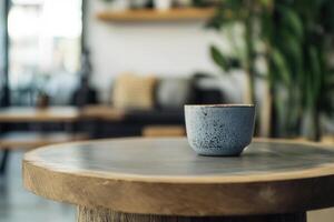 A cozy setting with a cup on a wooden table. photo