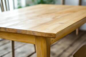 Close-up of a wooden table surface in a bright room. photo