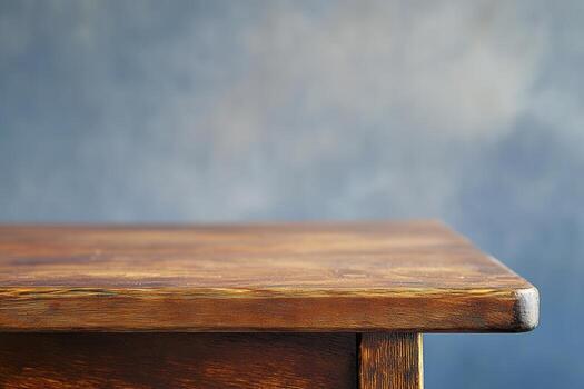 Close-up of a wooden table edge against a blurred background. photo