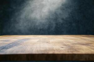 Wooden table with a spotlight effect on a dark background. photo