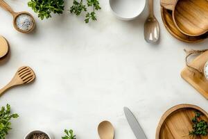 Kitchen utensils and herbs arranged on a countertop. photo