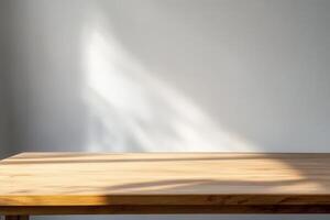 Simple wooden table with soft shadows on a wall. photo