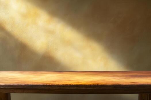 Soft light illuminating a wooden table against a textured wall. photo